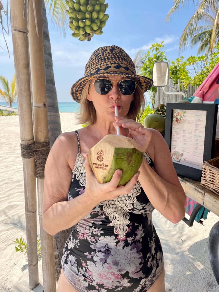Sipping from a coconut on Fushifaru Maldives