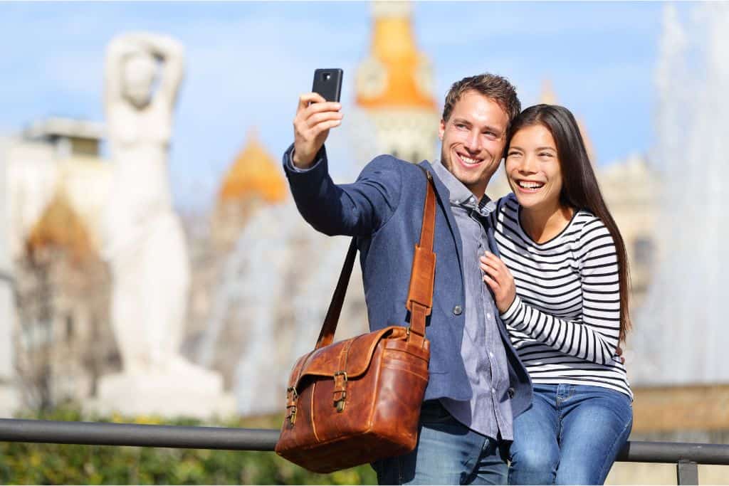A couple shares a selfie at Park Guell in Barcelona, Spain