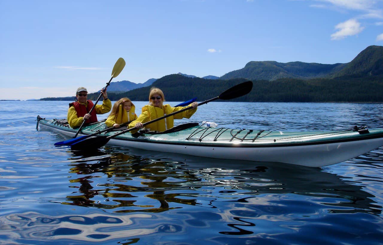 a family kayaking in Alaska